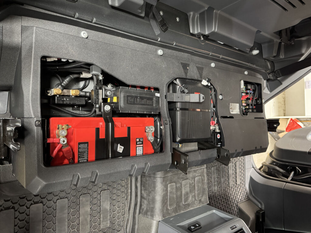 The REDARC 150Ah Lithium Battery fits perfectly into the Ineos Quartermaster's factory compartment, providing high-capacity power without losing space