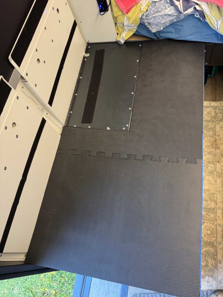 High-density foam padding installed over the battery housing to provide structural support for the bench cushions