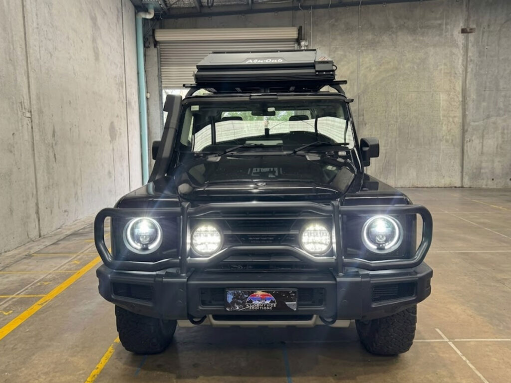 Full vehicle front view demonstrating the balanced high-output forward lighting setup