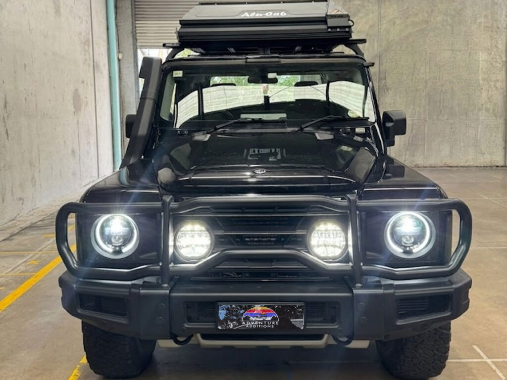 The completed upgrade displaying the illuminated driving lights positioned behind the protective front bar