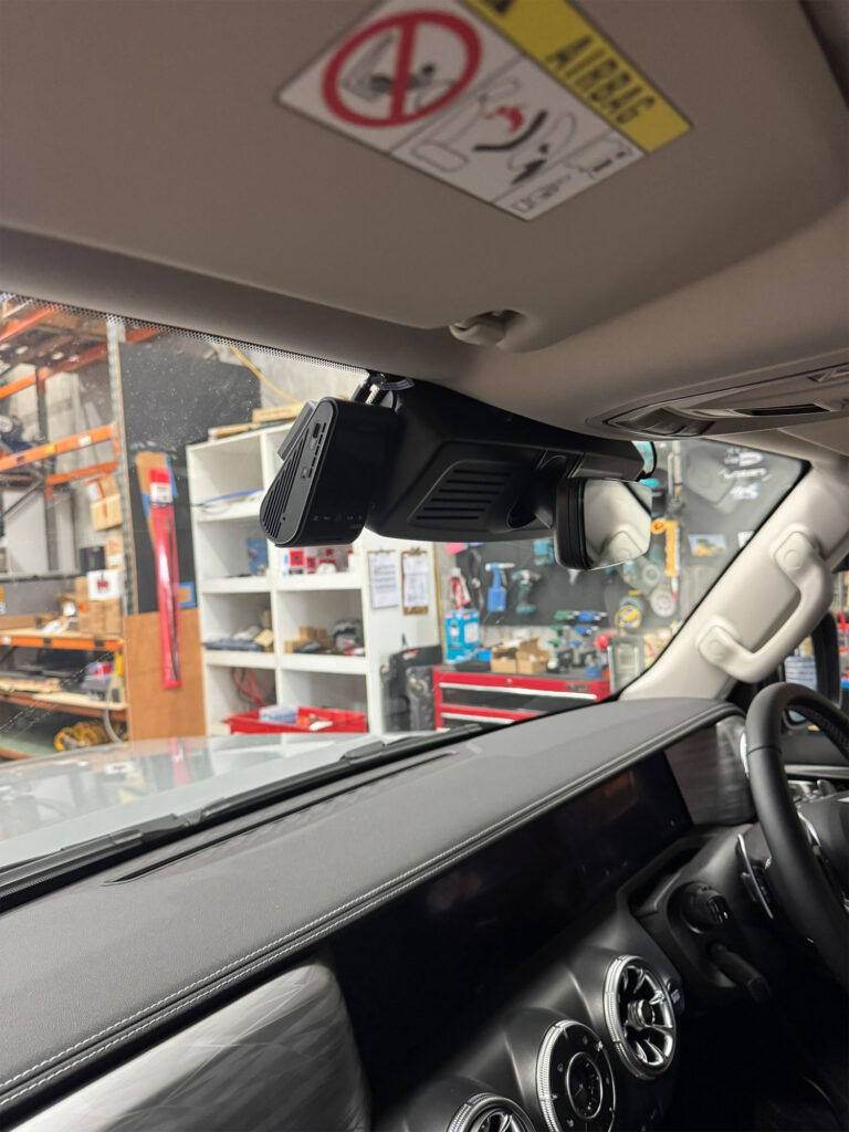 Viofo A229 Pro front camera positioned neatly behind the central rear-view mirror for full forward vision without blocking driver sightlines