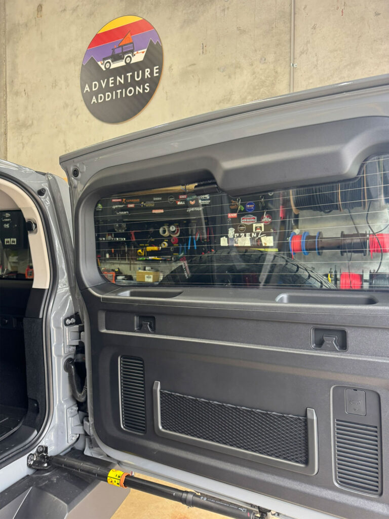 Viofo A229 Pro rear camera installed at the top of the tailgate glass, with wiring routed through factory door seals for a clean look