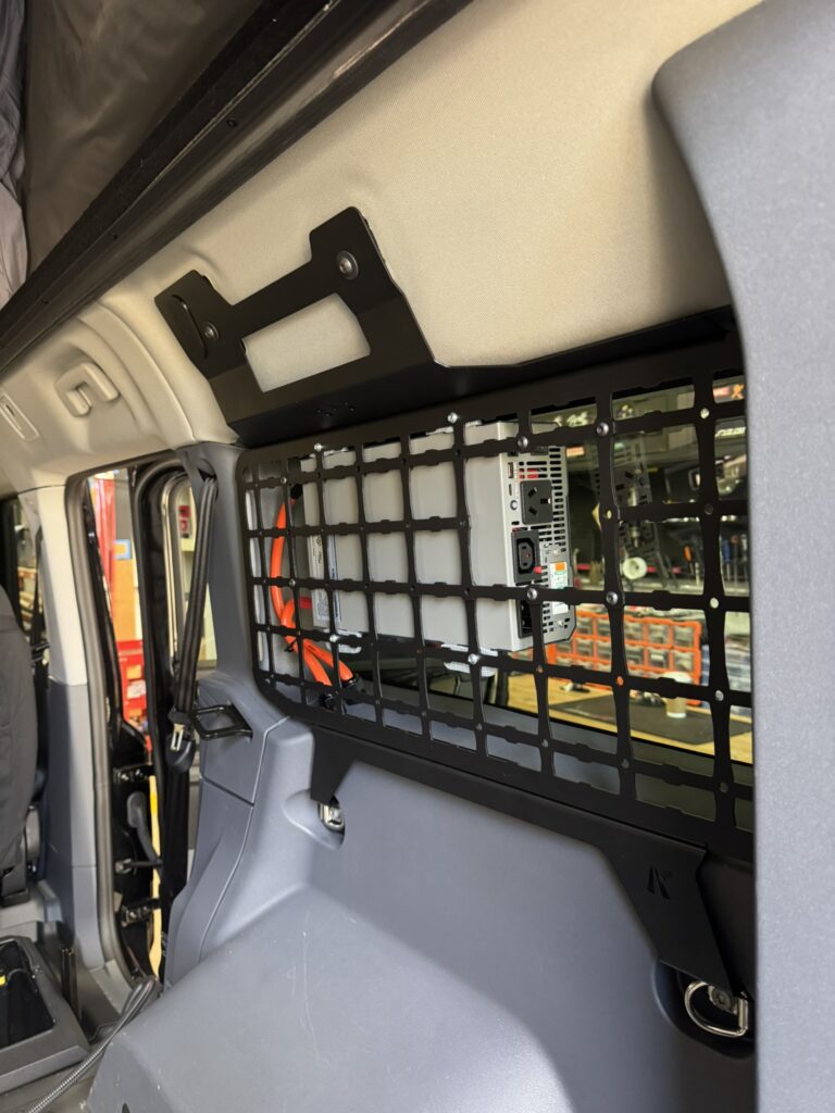 Power inverter mounted securely onto side molle panels