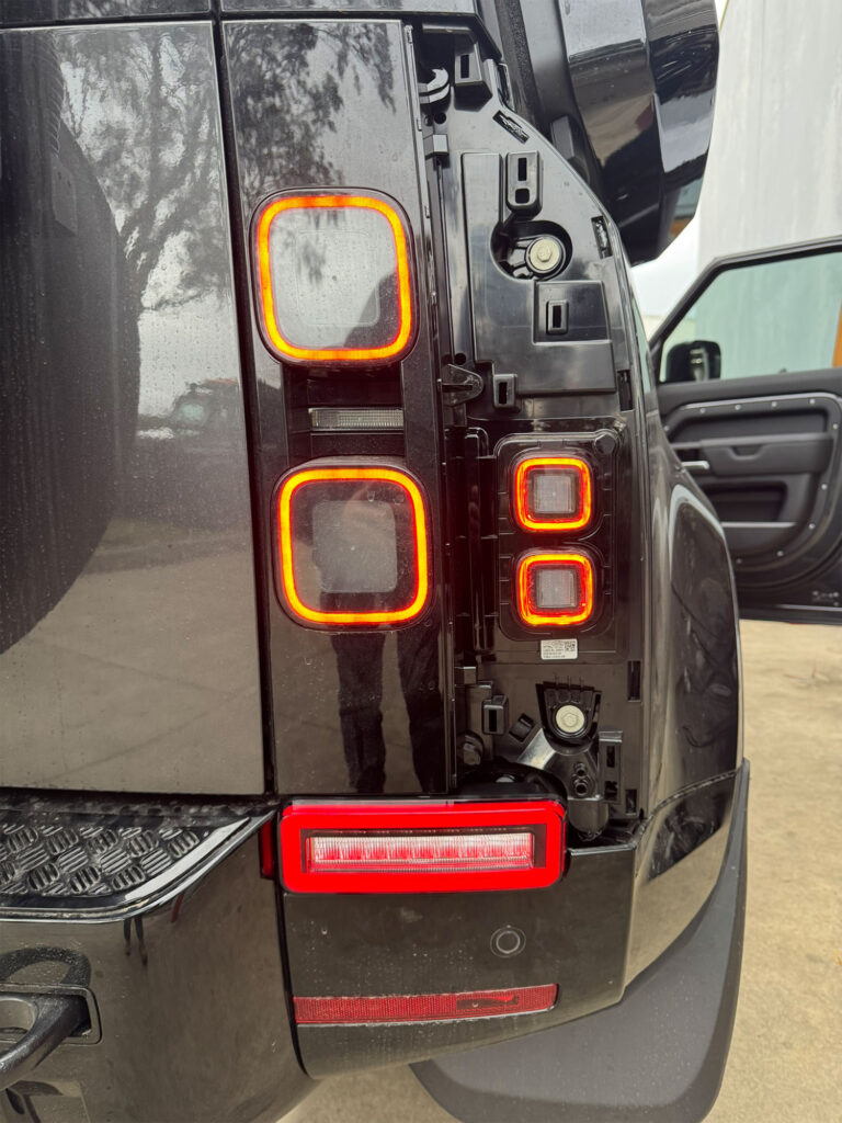 Close-up of the driver-side rear light showing the smoked LED tail light and bumper reverse light