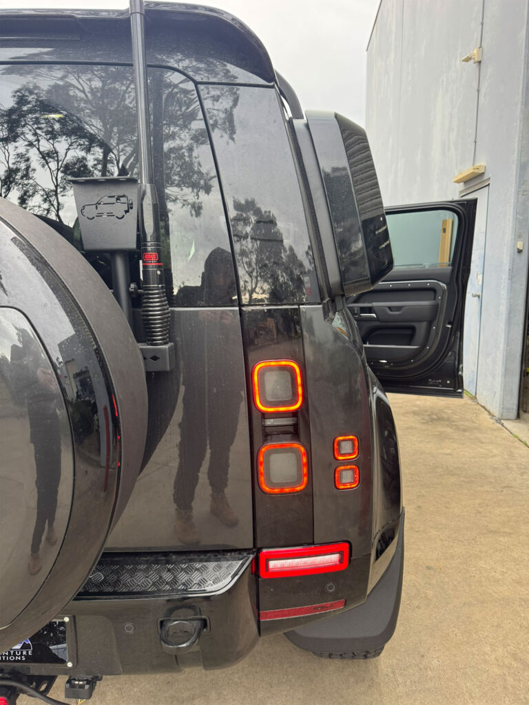 Close-up of the passenger-side rear light highlighting the smoked housing and upgraded bumper reverse light
