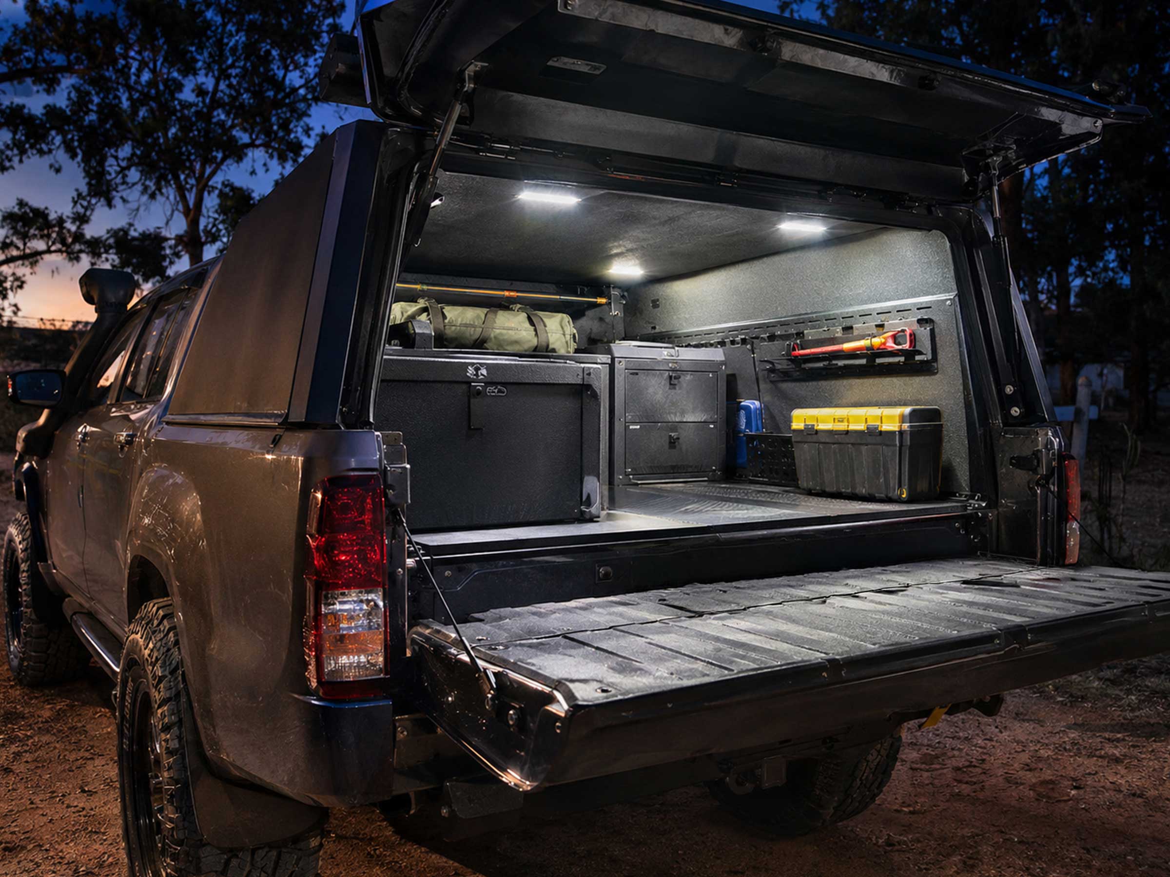Flood-beam work lights fitted inside a canopy, tray, or tailgate area