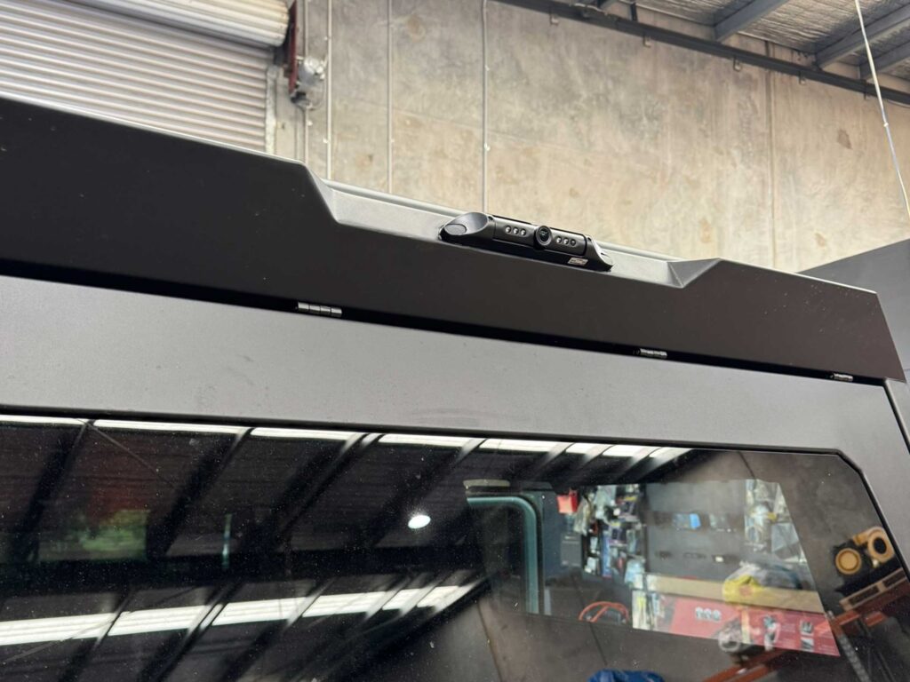 Safety Dave High-Definition Rear Vision Camera mounted flush to the upper rear canopy edge of the INEOS Grenadier Quartermaster.