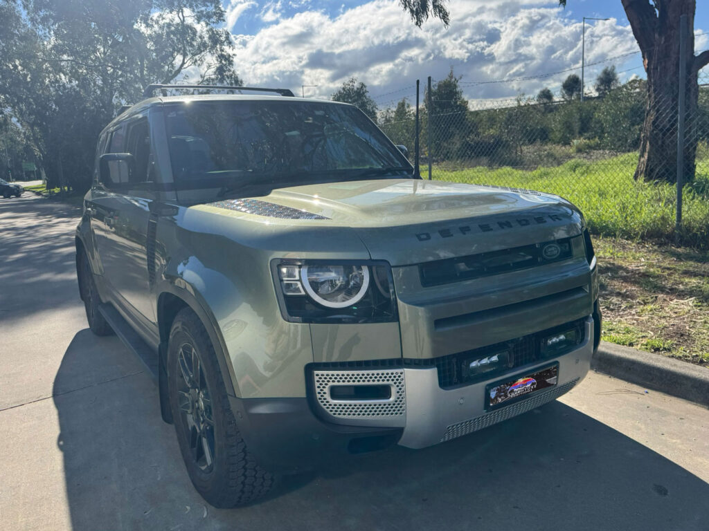 Completed Lazer Lamp grille integration on the 2025 Land Rover Defender showing flush fitment