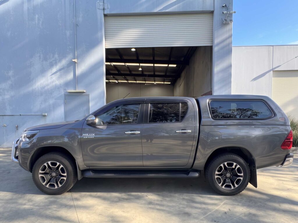 This is a side view of the 2023 Toyota Hilux SR5 Dual Cab with the canopy installed at the Braeside facility